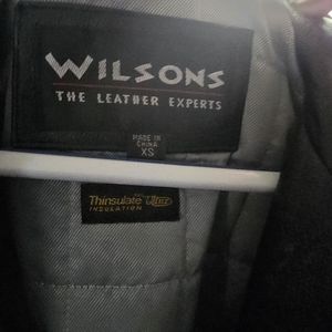 A leather trench coat by Wilson Leathers in size XS.